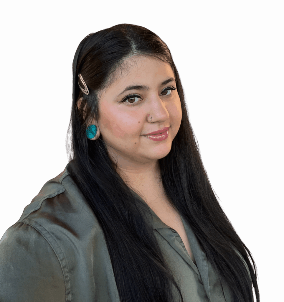 LeeAnna, a woman with long black hair is wearing a dark green shirt and turquoise earrings.