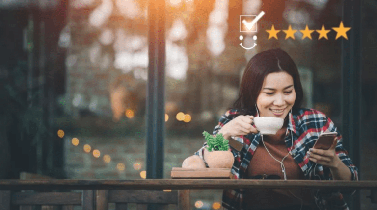 Customer leaving a 5 star review on her phone, a result of customer retention strategies